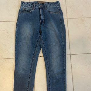 Leith straight leg denim with unfinished hem at bottom of leg.